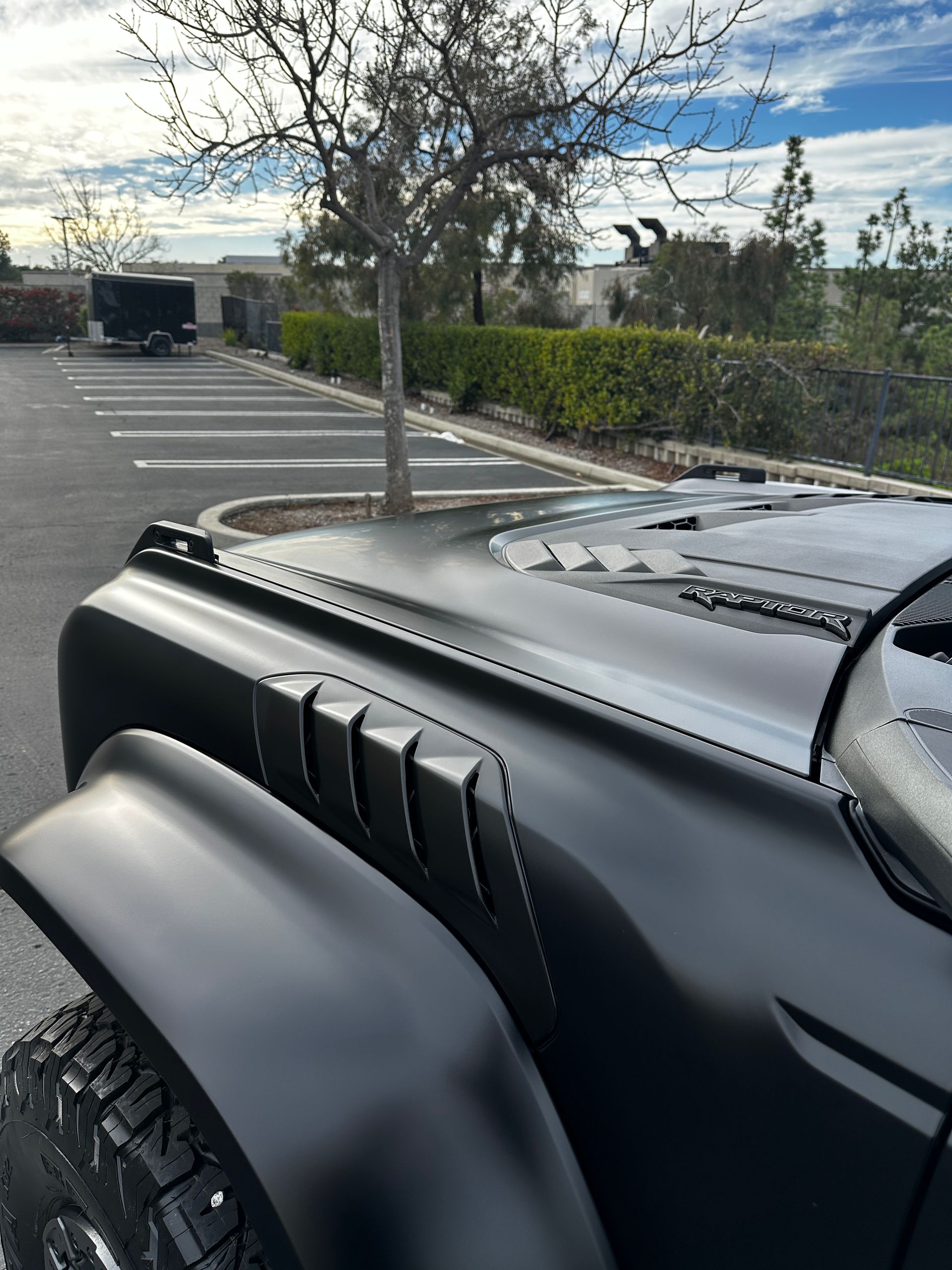 A black jeep is parked in a parking lot