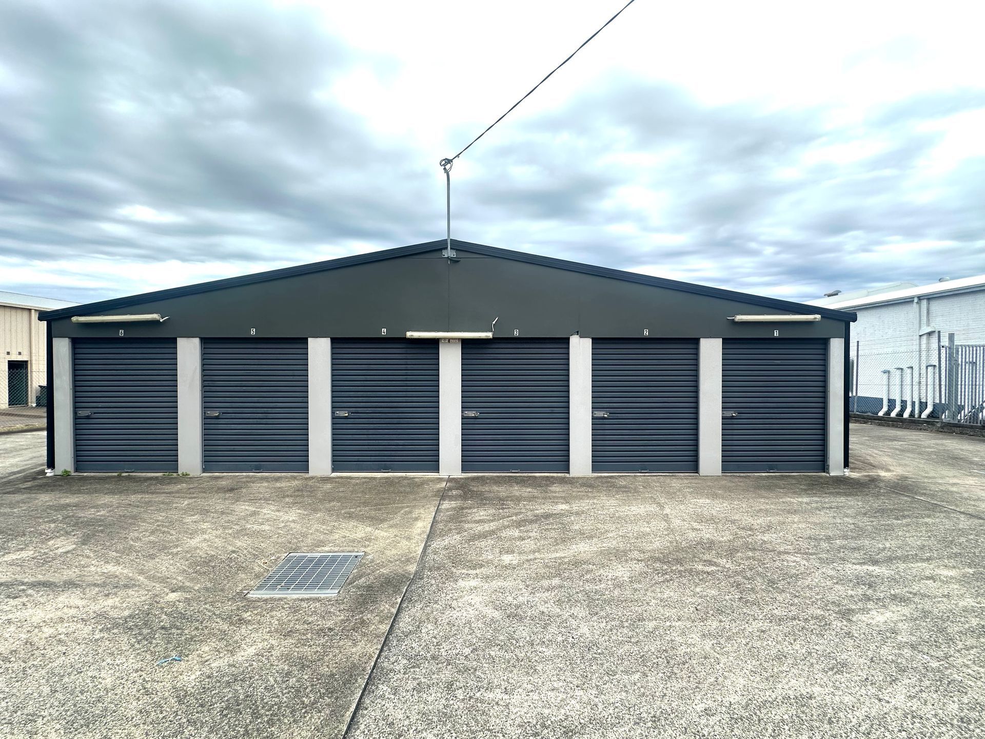 A Row of Empty Storage Units With Blue Doors — Coolabah Self Storage In Taree, NSW