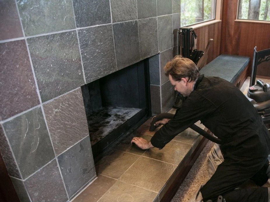 Derbyshire Tiling Specialists cleaning around a new tiled feature wall on a chimney breast in Derby