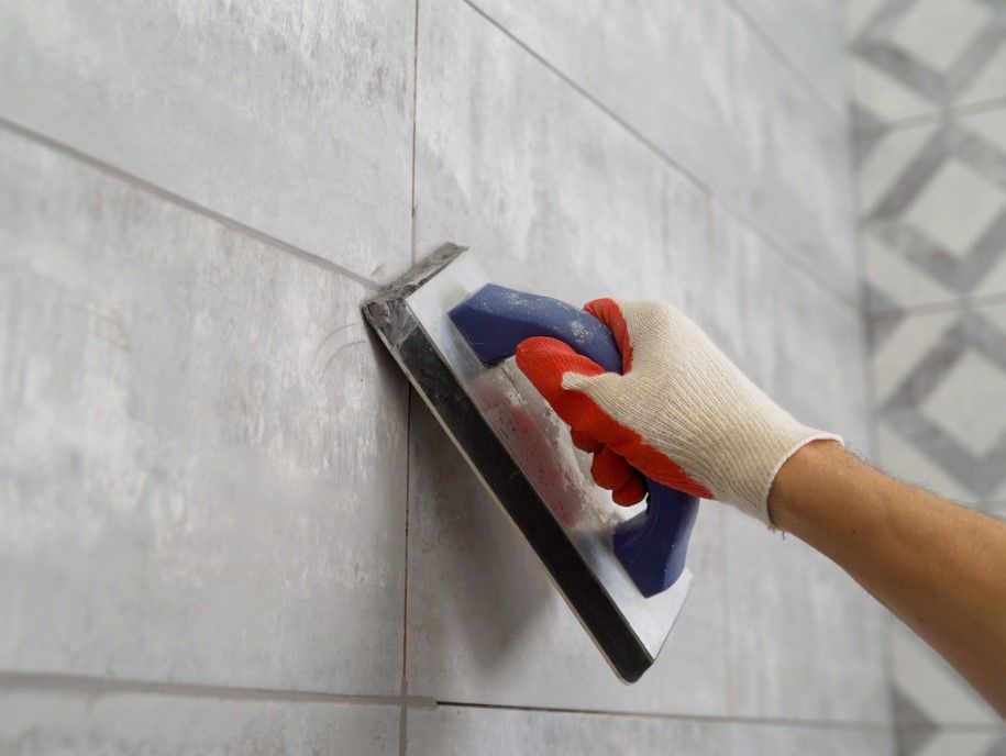 Derbyshire Tiling Specialists cleaning grout in a tiled bathroom in Derby