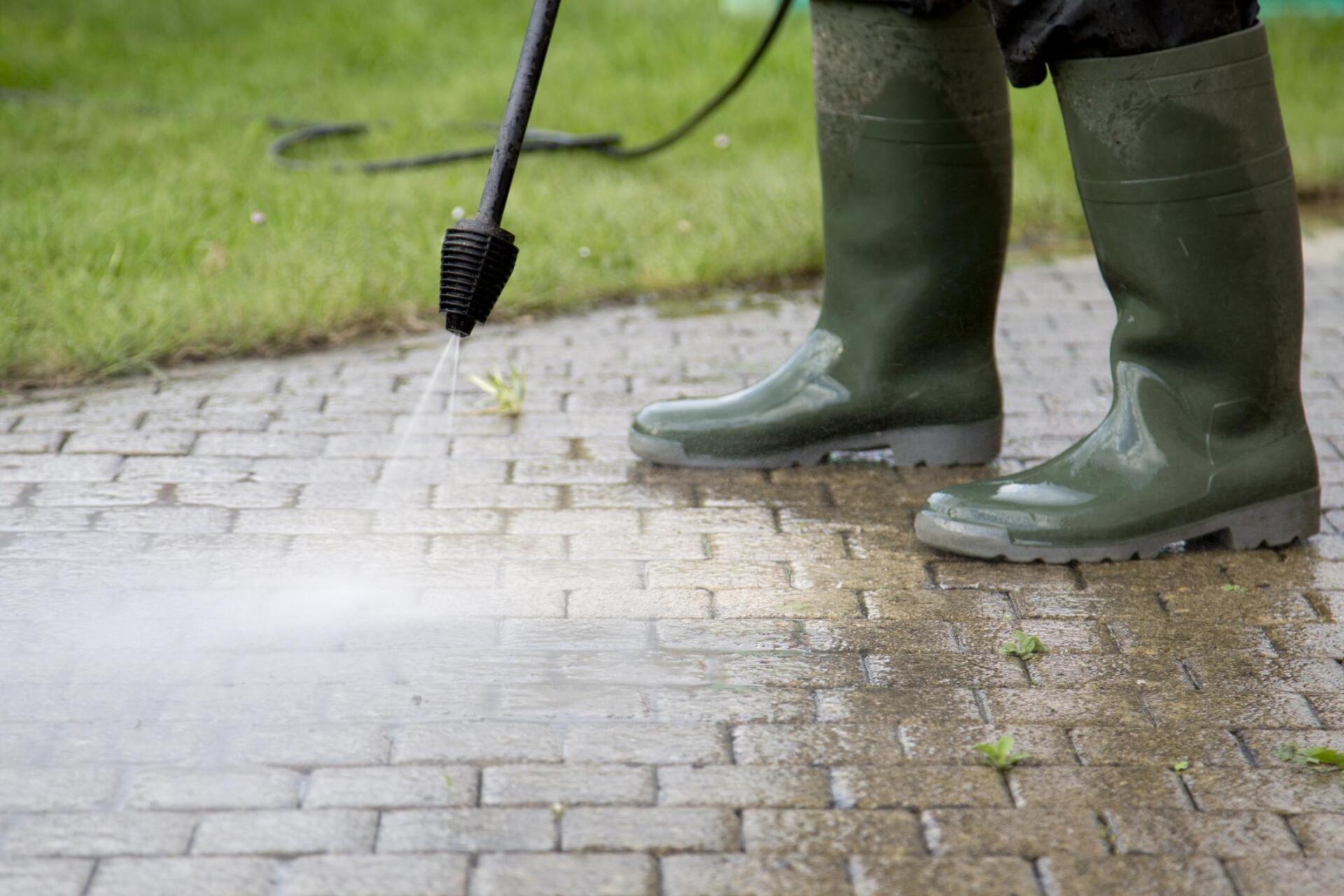 worker cleaning the walkway