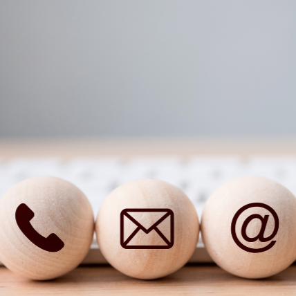 Three wooden balls with a phone envelope and email icons on them