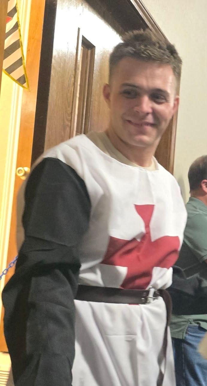 man smiling in Christian warrior outfit