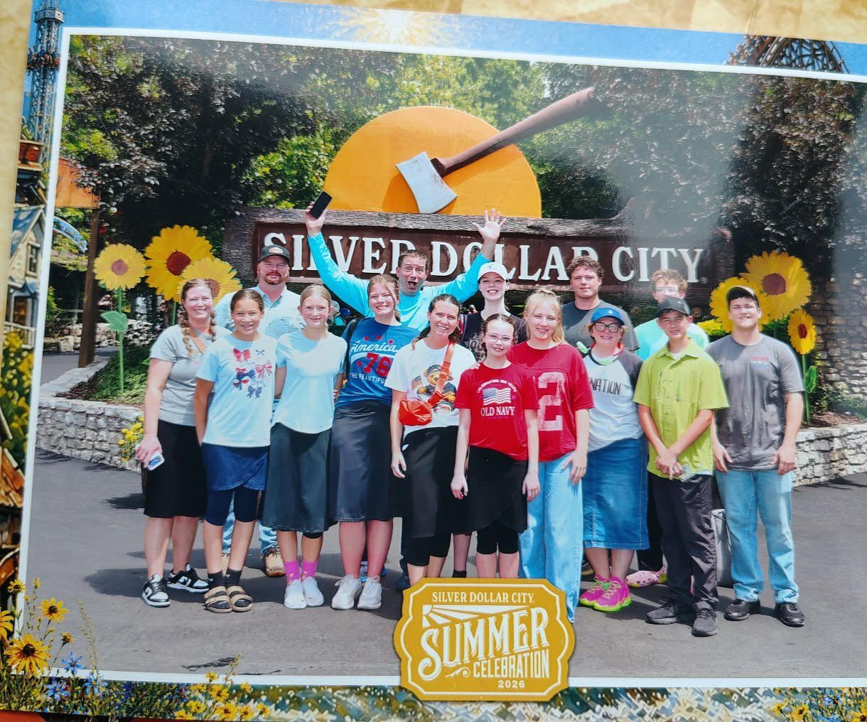 Group of children posing in front of the Silver Dollar City Summer Nights sign and giant guitar sculpture.