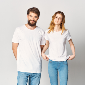 Two people in white T-shirts and blue jeans standing side by side against a plain background