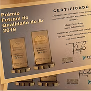 Certificate for “Prêmio Fetran de Qualidade do Ar 2019” with two gold-toned awards on a beige background