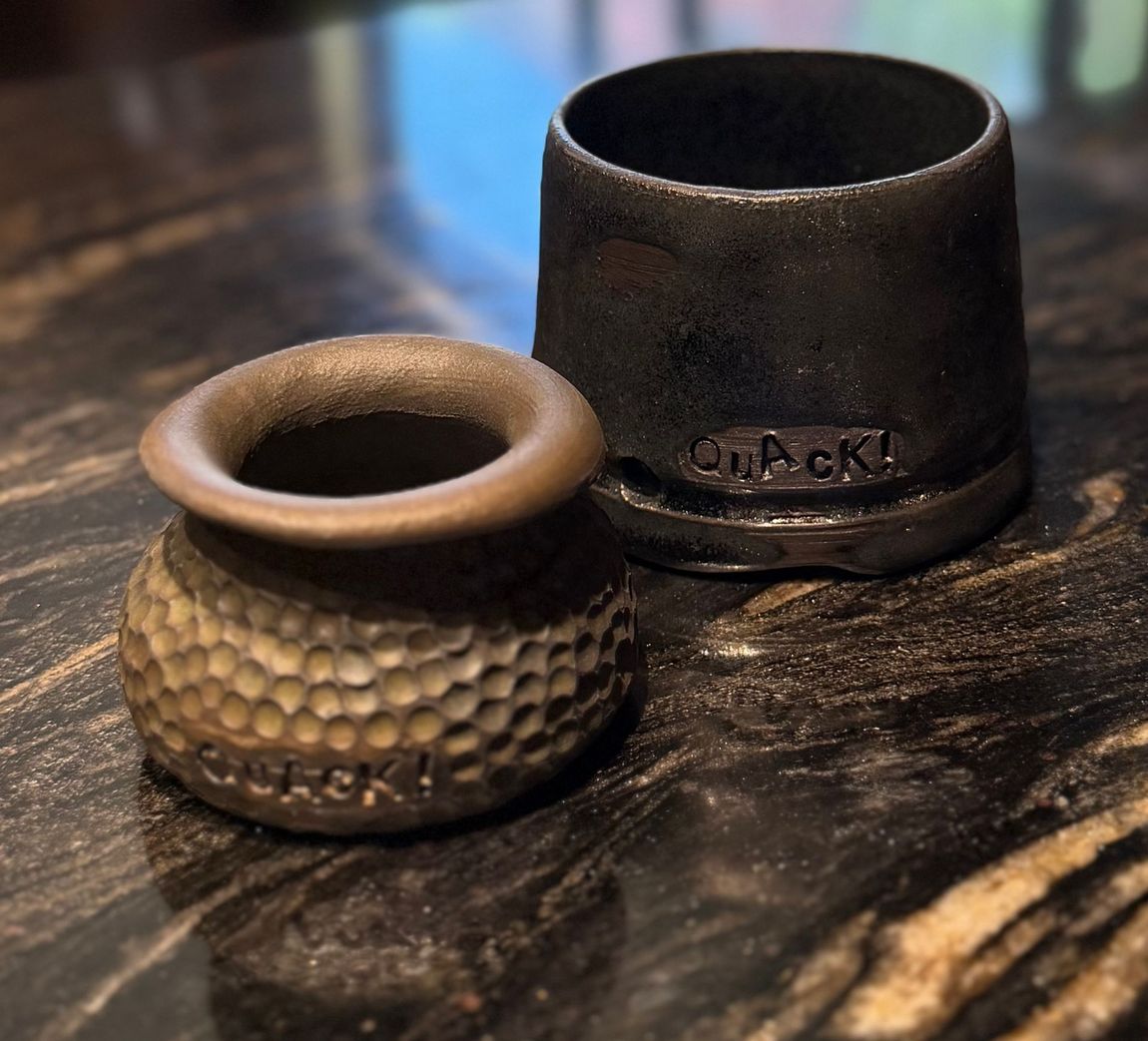 Two Quack pots sitting on a counter