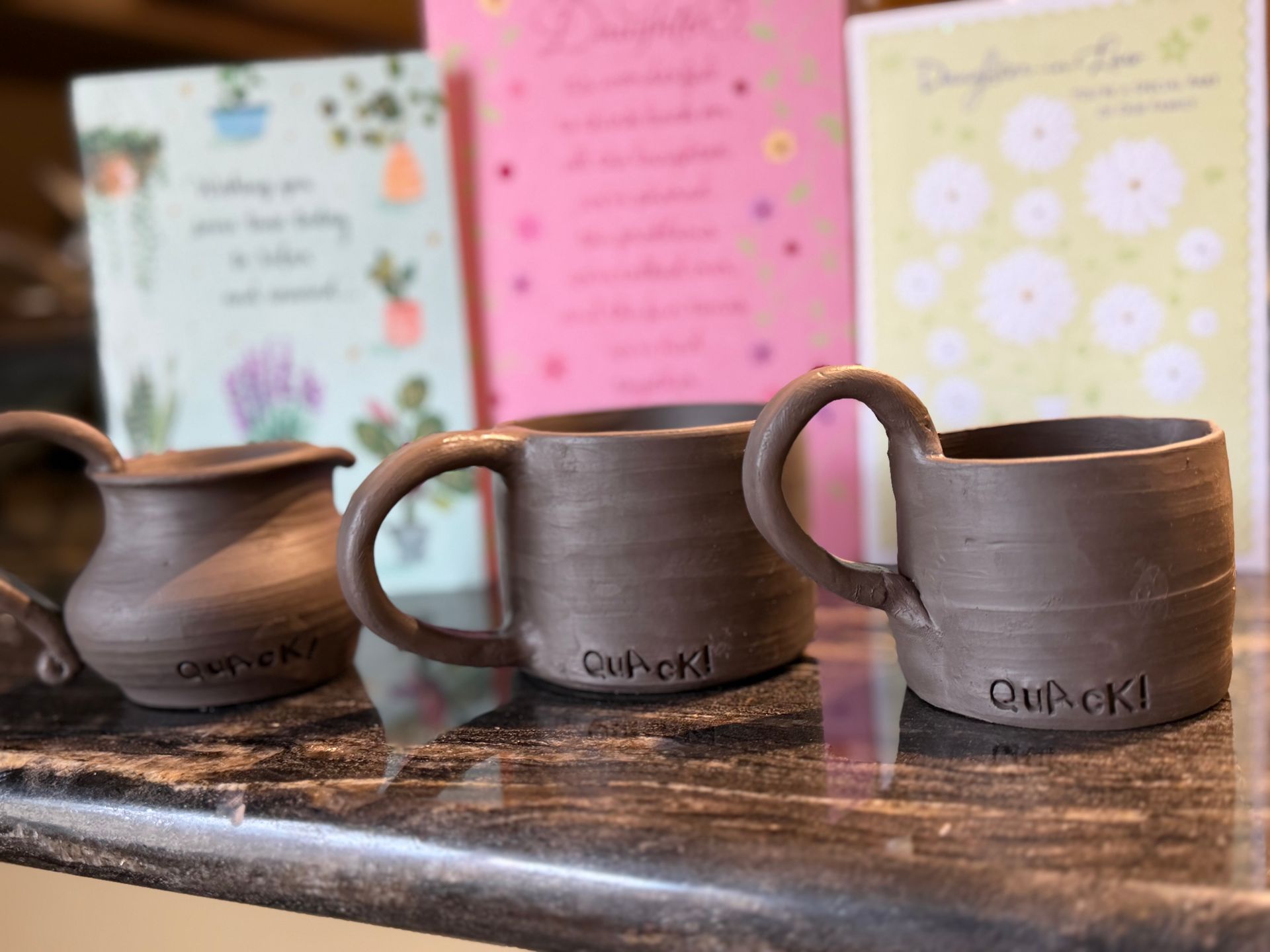 three small mugs on a counter