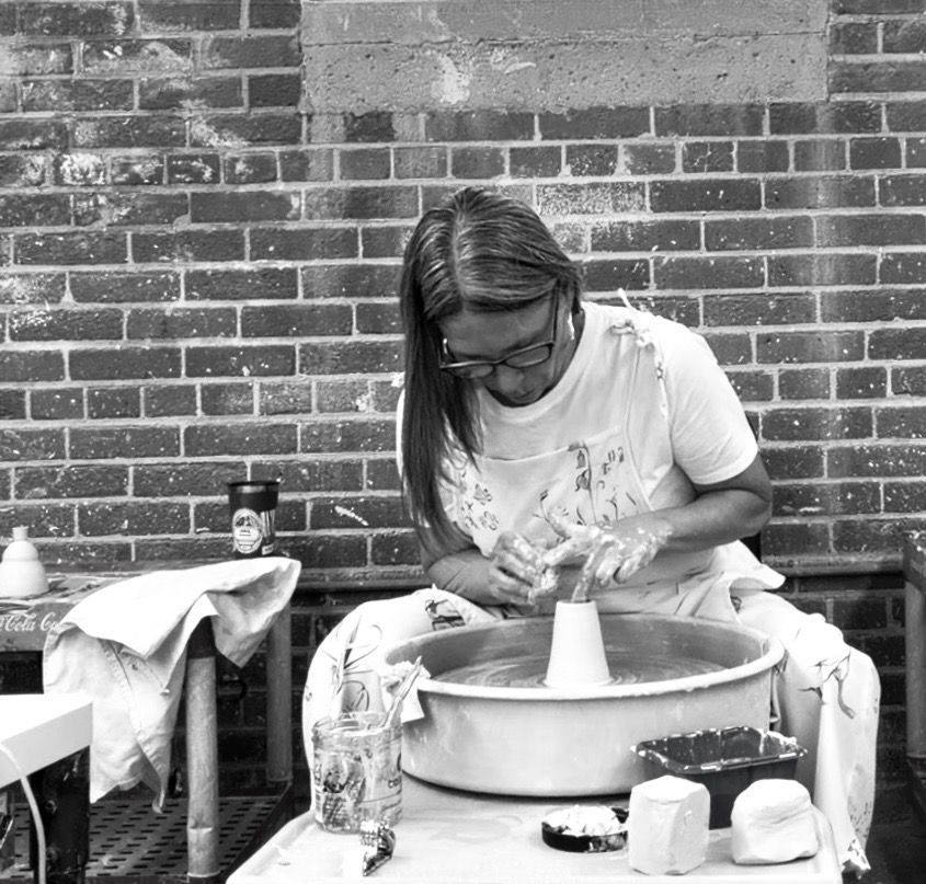 Tracy creating a handmade jar on the pottery wheel