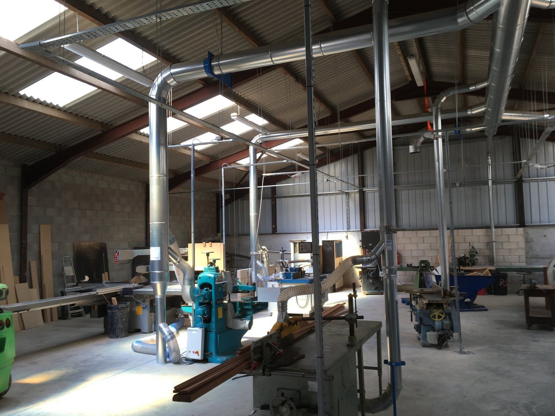a large warehouse with a lot of machinery and pipes