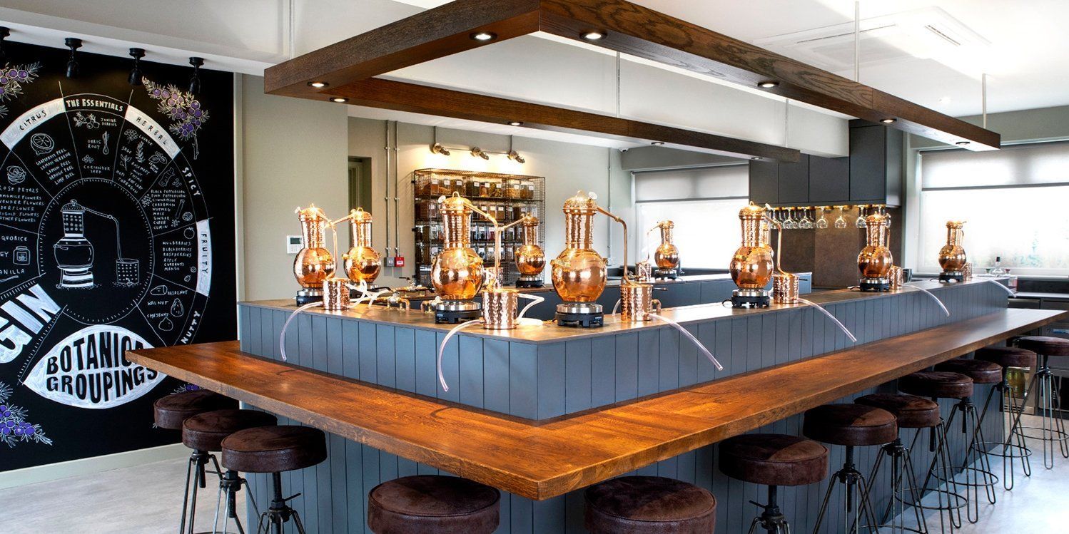 A long bar with stools in front of a wall that says science & cooking