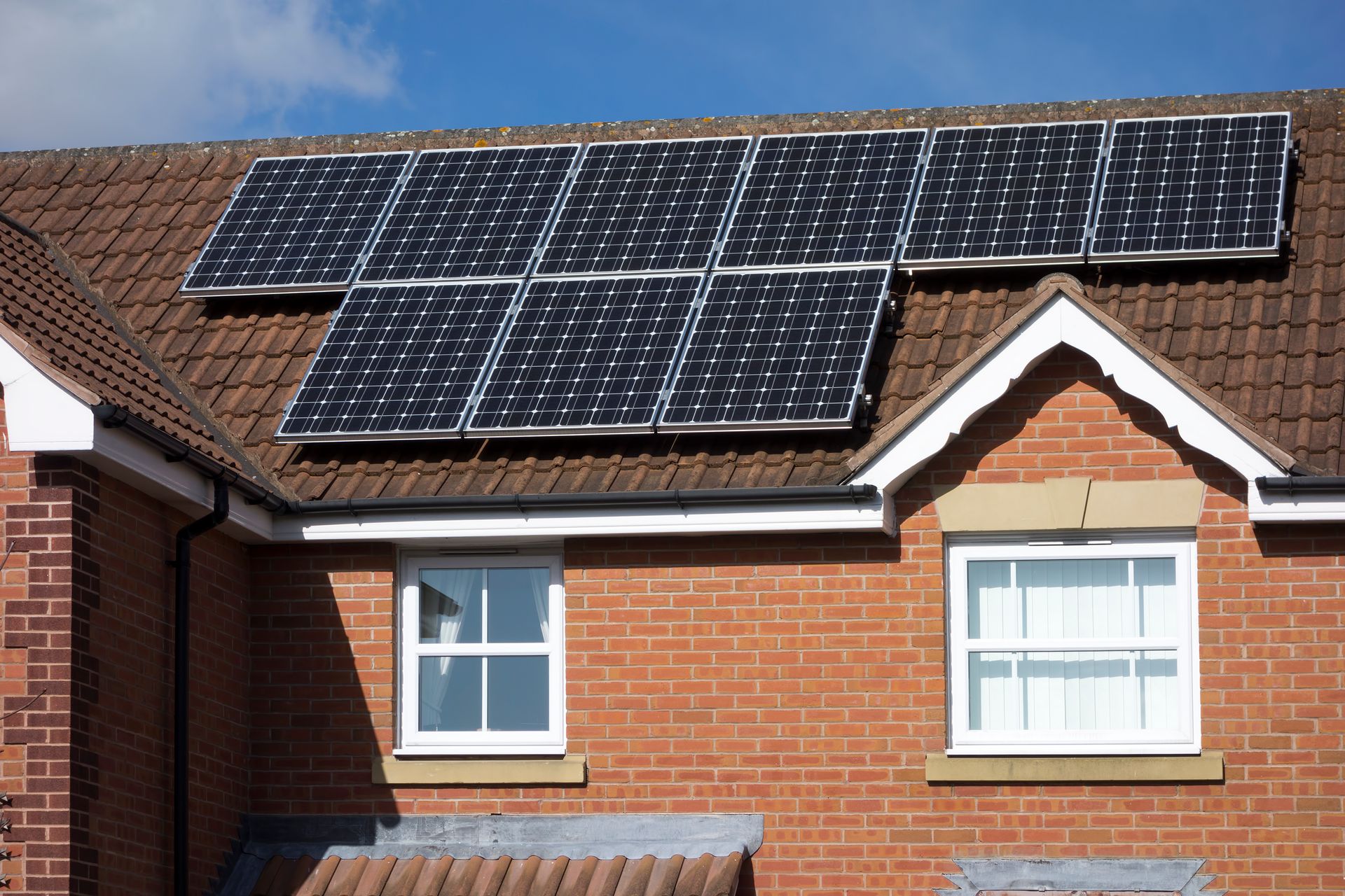 A brick house with solar panels on the roof
