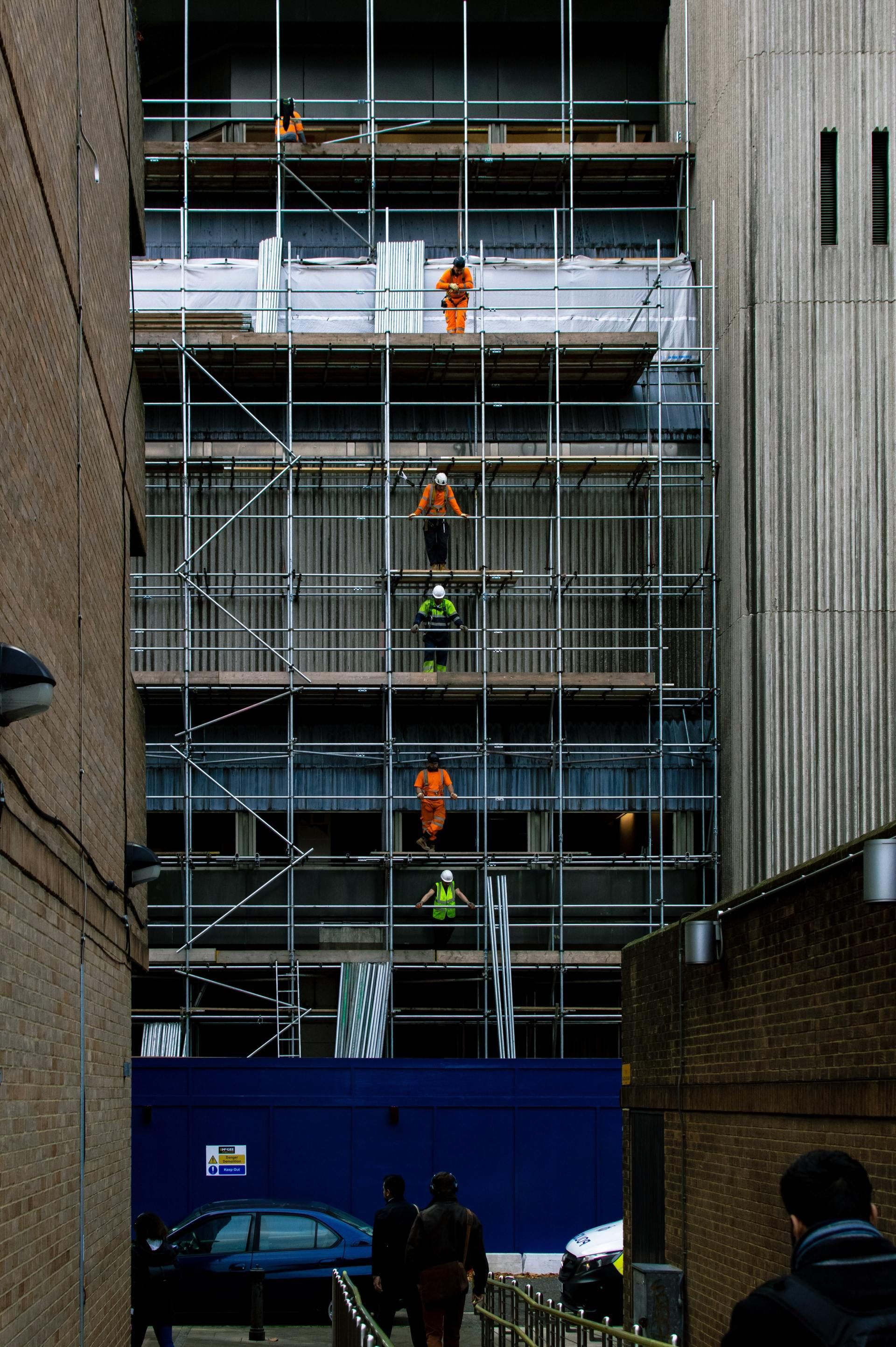 A building under construction with scaffolding on the side of it