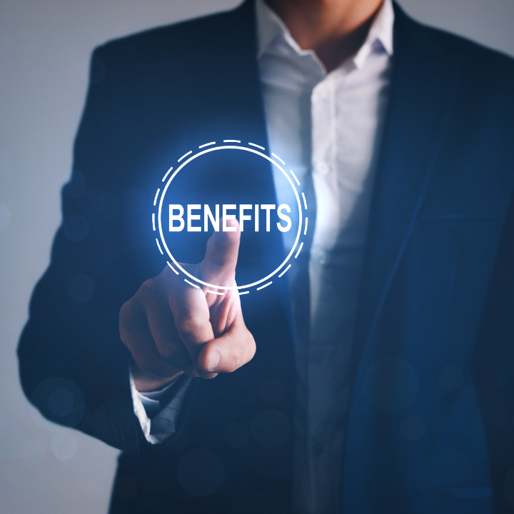 A man in a suit is pressing a button that says benefits