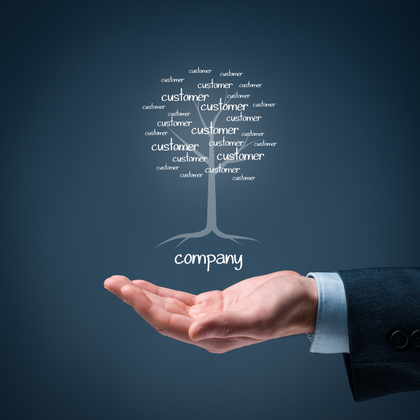 A hand holding a tree with the word company on it
