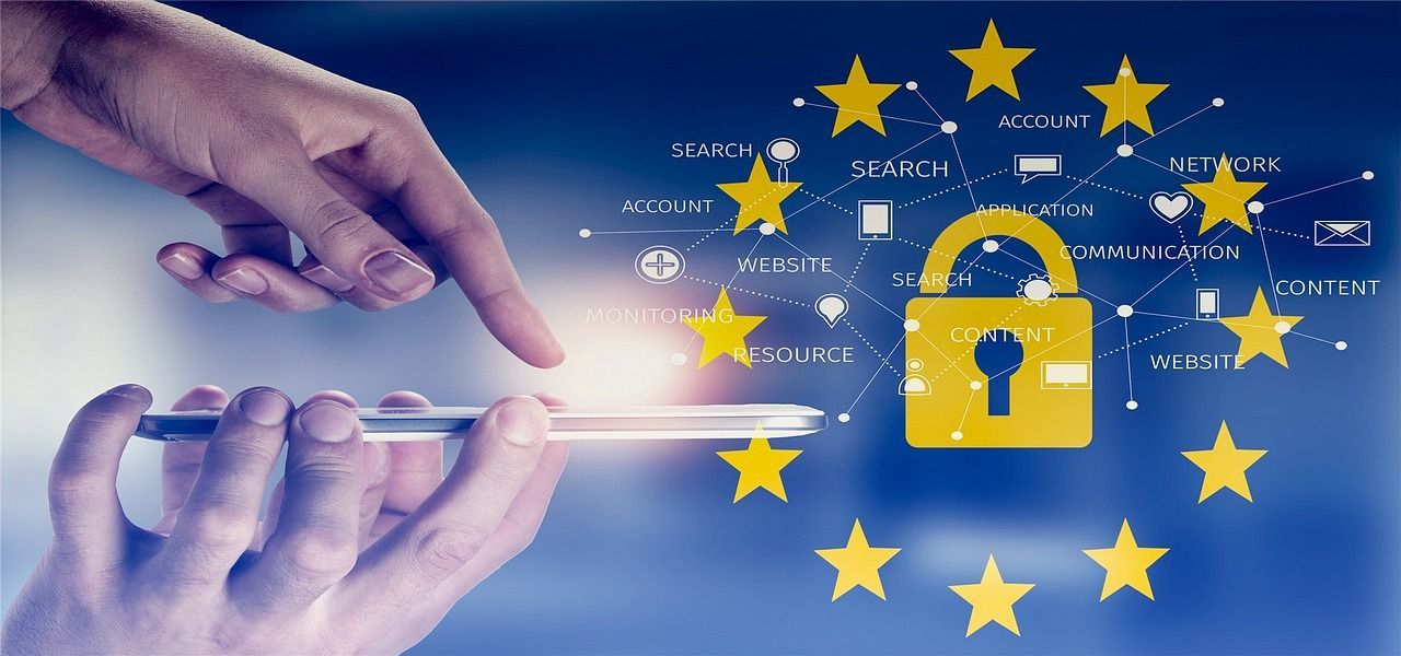 A person is holding a cell phone with a padlock and stars in the background.