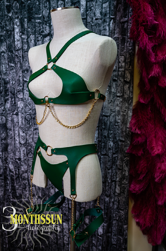 A mannequin is wearing a green bikini and garter belt.