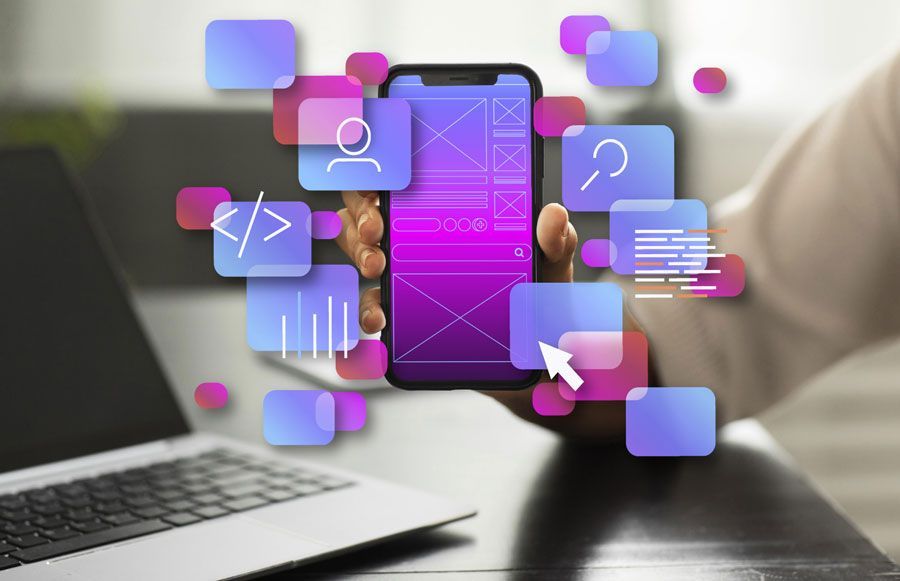 Image of a smartphone being held up with all kinds of html code sets and floating icons coming out of it