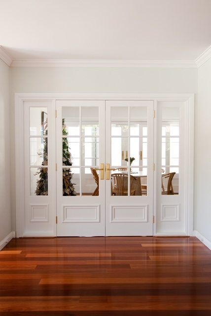 White French doors with glass panels in a bright room and polished wood floor
