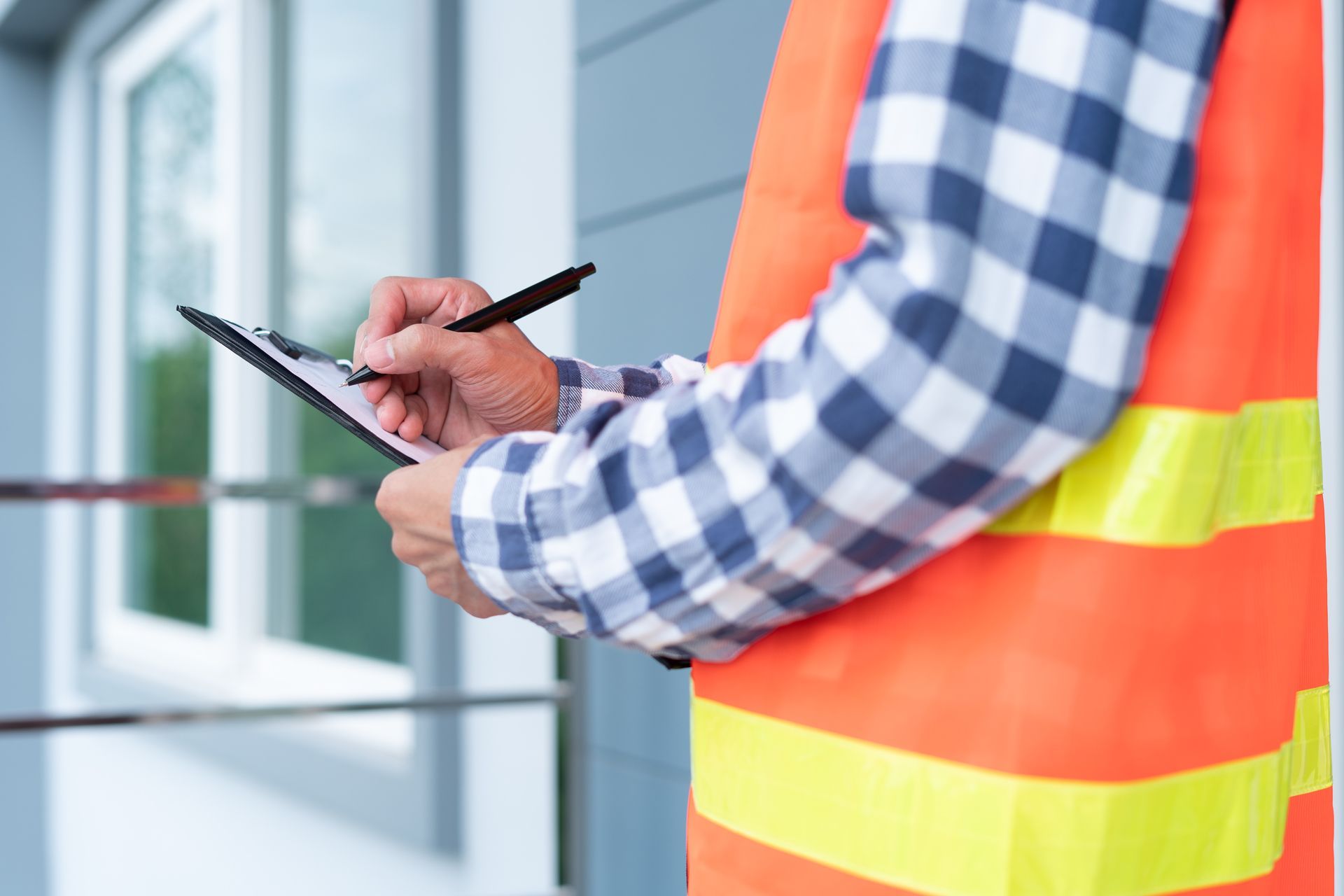 Contractor Writing on Clipboard