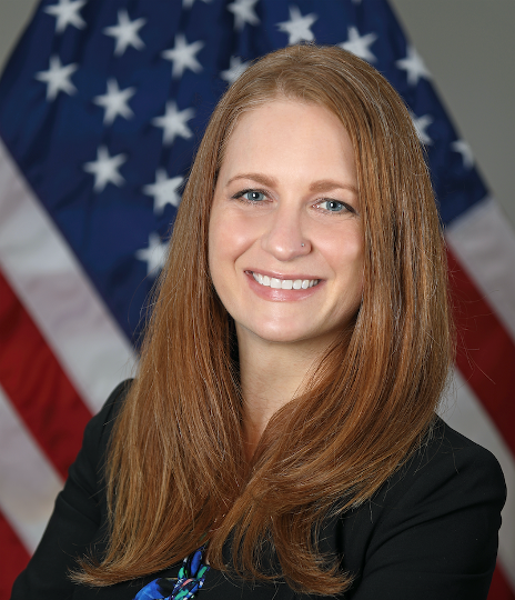 Picture of Tara Schwetz (white woman with red hair and blue eyes) wearing a black blazer