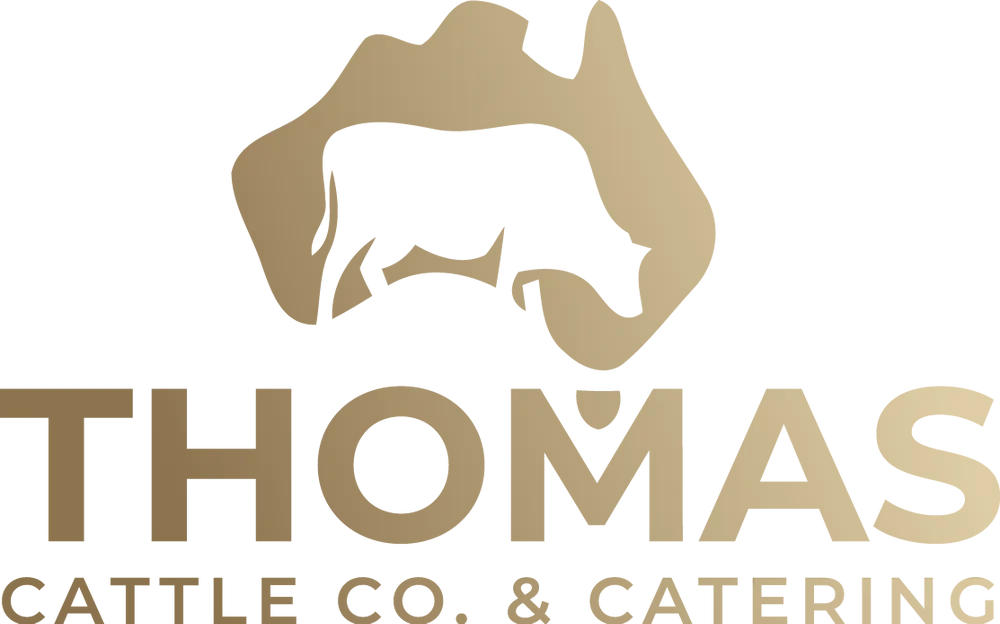 Logo for Thomas Cattle Co. & Catering: a cow silhouette inside Australia's shape, gold on white, with company name below.