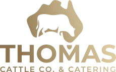 Logo for Thomas Cattle Co. & Catering: a cow silhouette inside Australia's shape, gold on white, with company name below.
