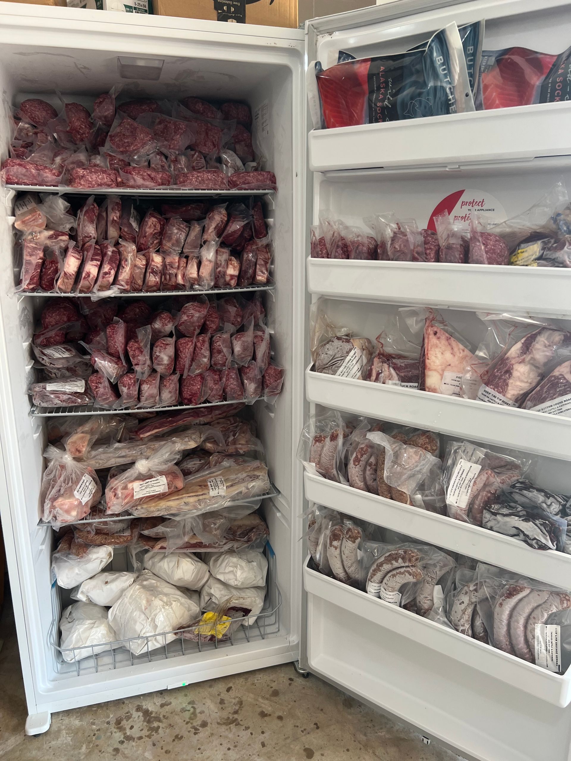 Freezer overflowing with wrapped meat. Quarter + Cow Fresh beef