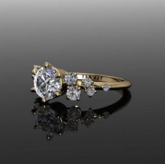 Gold ring with a large oval diamond and smaller stones on a black reflective surface