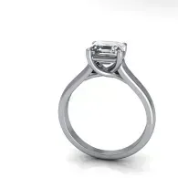 Silver solitaire ring with a clear gemstone on a white background