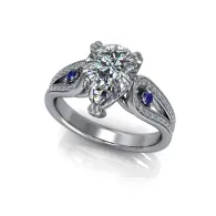 Silver ring with a central diamond cluster and two blue side stones
