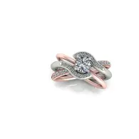 Rose gold and silver intertwined ring with a heart-shaped diamond center