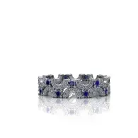 Silver floral ring with blue gemstones on a white background
