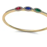 Gold bracelet with three oval gemstones in red, blue, and green