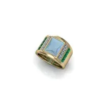 Gold ring with a large blue square gemstone and green side stones on a white background