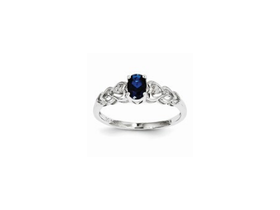 Silver ring with a dark blue oval gemstone and floral filigree accents
