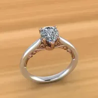 Diamond solitaire ring with a silver band on a wooden surface