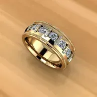 Gold ring with silver-toned band and square clear stones on a wooden surface