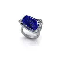 Silver ring with a large blue gemstone and small clear stones on the band