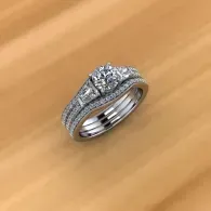 Silver diamond ring on a wooden surface