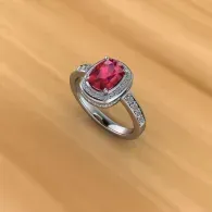 Silver ring with a large pink gemstone on a warm-toned surface