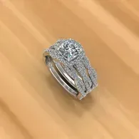 Diamond engagement ring with silver band on a light wooden surface