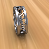 A silver ring-like wheel with crisscross spokes on a blurred tan background