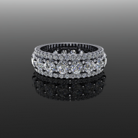 Silver gemstone eternity ring on a glossy black reflective surface