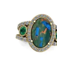 Gold ring with large oval green opal and smaller green gemstone accents
