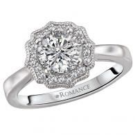 Silver diamond halo engagement ring with a round center stone on a white background