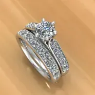 Diamond engagement ring with silver band on a warm wooden surface