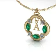 Gold necklace with a circular pendant, green gemstones, and a hanging letter A charm