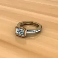 Silver ring with a rectangular clear gemstone on a wooden surface