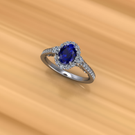 Silver ring with an oval blue gemstone and small side diamonds on a warm wooden surface